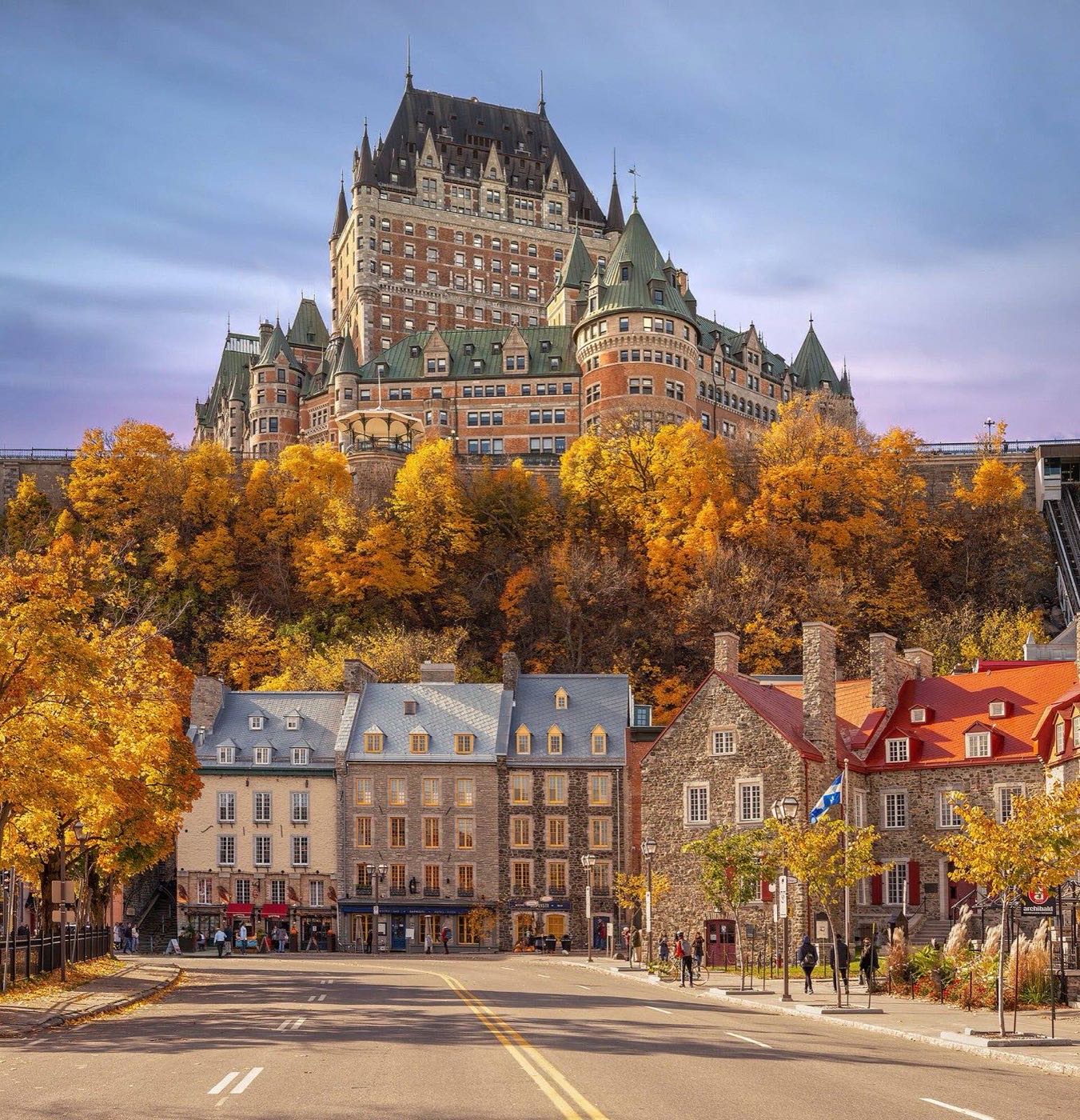The Château Frontenac towering over autumn trees and the streets of Old Quebec