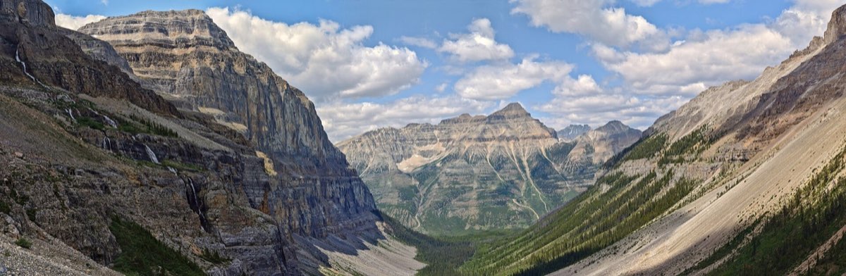 Highway winding through a forested mountain valley in Kootenay National Park