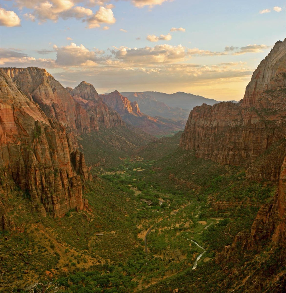 Red and cream sandstone walls of Zion Canyon with the Virgin River below